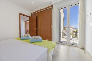 En eller flere senge i et værelse på Villa Cel