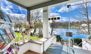a room with a large window with a view of a lake at Haus Hufeland in Bad Salzungen