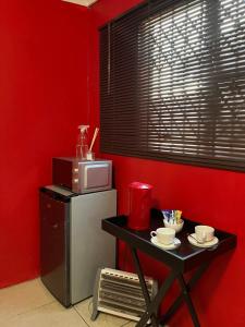 a kitchen with a small table and a microwave at Grey house lodge in Pietermaritzburg