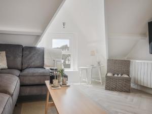 a living room with a couch and a table at Fore Street House - Apartment 3 in Seaton