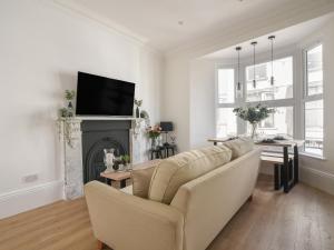 a living room with a couch and a fireplace at Fore Street House - Apartment 2 in Seaton