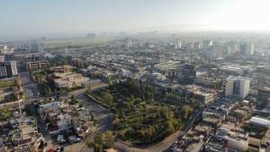 an aerial view of a city with buildings at Fareeq Hotel in Erbil