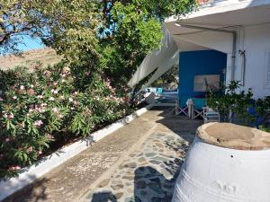 a porch of a house with a garden with flowers at Ble 1BR Vacation Home with Private Terrace in Chania Town