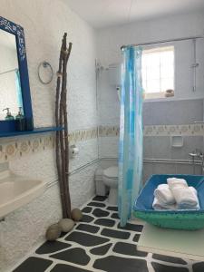 a bathroom with a sink and a toilet and a mirror at Ble 1BR Vacation Home with Private Terrace in Chania Town
