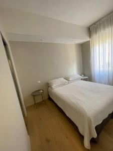 Un dormitorio con una gran cama blanca y una ventana en Via Scernio 2 PT, en Bonassola