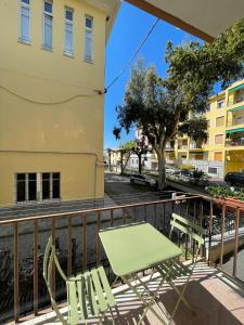 - Balcón con mesa verde y sillas en Via Scernio 2 PT, en Bonassola