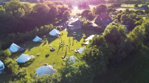 an aerial view of a group of tents on a field at Ingerichte Boho, Indian of Tropical Bell Tent met alpaca's in Paasloo