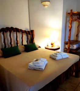 a bedroom with a bed with towels on it at Masseria Quis Ut Deus in Crispiano