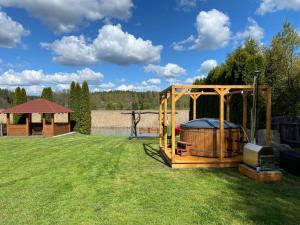 a large wooden gazebo with a gazebo at Apartament 2 Nad Babięcką Strugą in Piecki