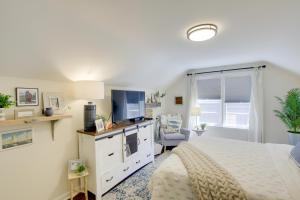 a bedroom with a white bed and a tv at Family Home 1 Block to Lake Michigan Beach! in Sheboygan