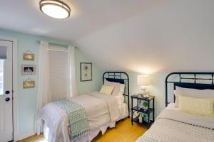 a bedroom with two beds and a window at Family Home 1 Block to Lake Michigan Beach! in Sheboygan