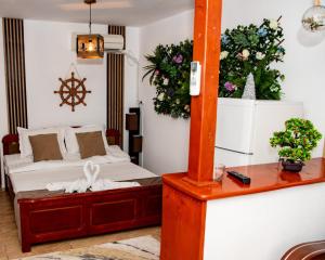 a bedroom with a bed and many plants on the wall at Casa Ecaterina 2 Mai in 2 Mai