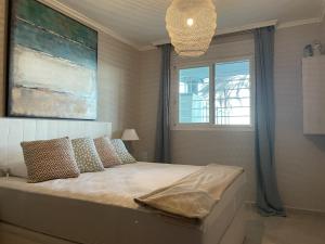 a bedroom with a large bed with a window at Residencial Mar de Denia 2 in Denia