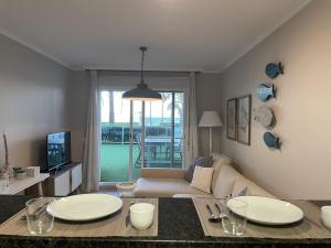 a living room with two tables and a couch at Residencial Mar de Denia 2 in Denia