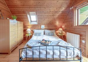 a bedroom with a bed with a tray of food on it at Pumpkin Lodge in Menai Bridge