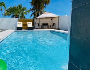 a swimming pool with chairs and a gazebo at Whole Apartment/Private Pool/Netflix/Wifi in Carolina