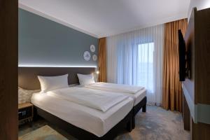 Postel nebo postele na pokoji v ubytování ibis Styles Kiel City