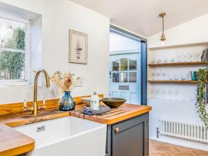 a kitchen with a sink and a counter at Charming Downland Cottage - Pass the Keys in Chichester +57 photos