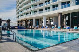 a large swimming pool in front of a hotel at Stunning Condo 2/2 At Hyde BeachResort Beach Front in Hollywood