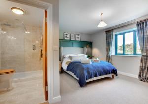 a bedroom with a bed and a shower at Rocks Cottage in Builth Wells