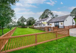 a wooden fence in front of a house at Top Y Nant in Mold
