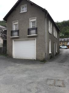 a brown brick house with two garage doors at Laporte in Luz-Saint-Sauveur