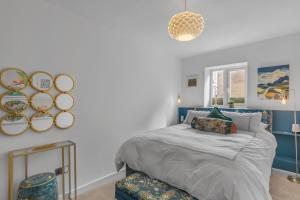 a bedroom with a bed and mirrors on the wall at Duke Street brand new central 1 bed flat in Norwich
