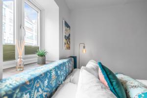 a living room with a couch and a window at Duke Street brand new central 1 bed flat in Norwich