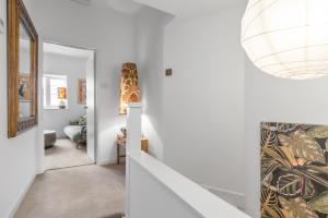 a hallway with white walls and a staircase with a patterned wall at Duke Street brand new central 1 bed flat in Norwich