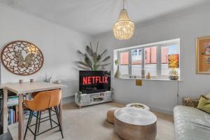 a living room with a tv and a table at Duke Street brand new central 1 bed flat in Norwich
