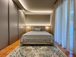 a bedroom with a large bed and a large rug at Acquamarina Luxury House in Aci Castello