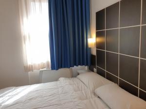 Giường trong phòng chung tại Hotel Vitruvio