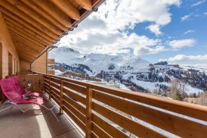 a person sitting on a bench in the snow at Sun Valley Residence in La Plagne