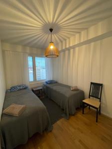 1 Schlafzimmer mit 2 Betten und einem Kronleuchter in der Unterkunft Arctic Deluxe Residence in Rovaniemi
