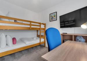 a room with a table and a bunk bed at Valley Rise By My Getaways Free Parking in Portslade