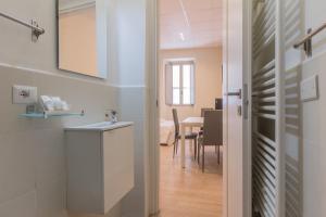 a kitchen with a sink and a dining room at Center Rooms in Piacenza