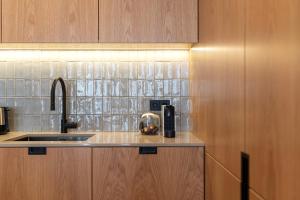 a kitchen with a sink and a coffee maker on a counter at Ando Living - Santa Catarina Townhouse in Porto