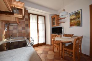 a kitchen with a table and a dining room at RAINBOW in Rovereto