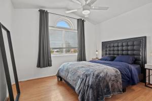 a bedroom with a large bed and a window at Work, Life, Luxury! Luxe Vegas Home w Firepit+Pool in Las Vegas