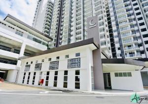 a large white building in front of tall buildings at Putrajaya 3R2B 10pax Acond Coway WiFi HyppTV Pool Gym Kitchen in Putrajaya