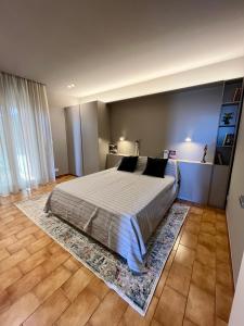 a bedroom with a large bed with a rug at Acquamarina Luxury House in Aci Castello