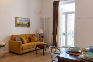 a living room with a couch and a table at Relais Palazzo Olimpia - Corso Vittorio Emanuele in Salerno