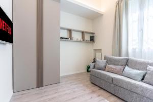 a living room with a couch and a window at Meneghina Suites Foresteria Lombarda in Milan