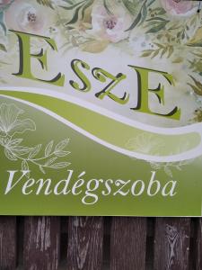 a sign for a spa in variegated flowers at EszE Vendégszoba in Tata