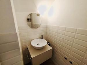 a bathroom with a white sink and a mirror at Casa Bella The First in Riomaggiore