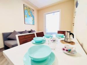 a dining room table with blue bowls and plates on it at Casa Bella The First in Riomaggiore +8 photos