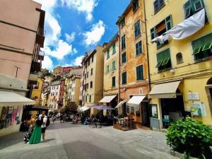 a group of people standing on a street with buildings at Casa Bella The First in Riomaggiore