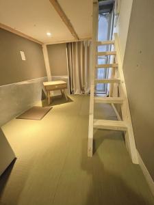 Postel nebo postele na pokoji v ubytování 誠家　MAKOTO HOSTEL