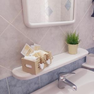a bathroom with a shelf with books and a sink at Appartamenti Il Glicine Villasimius in Villasimius