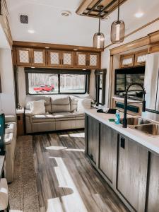 a kitchen and living room of an rv at Pigeon Forge Landing RV Resort in Pigeon Forge